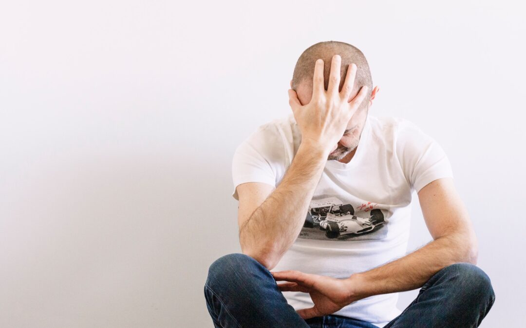 Man looking depressed with a hand in the head Man looking depressed with a hand in the head